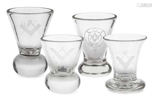 A group of four Masonic firing glasses, late 19th/early 20th century, with conical form bowls,