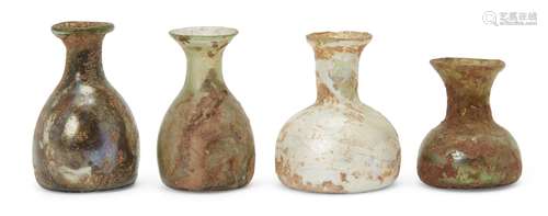 Four Roman miniature glass vessels, circa 1st-4th century AD, all with squat body and fared rim,