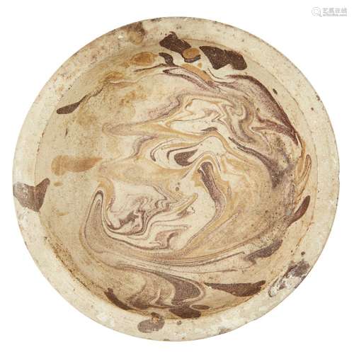 A marbled pottery dish, possibly Byzantine, 10th-12th century or later, on a short foot with everted