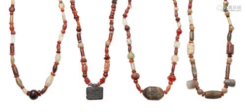 Four hardstone necklaces, comprised of ancient and modern beads, carnelian, amber, rock crystal,