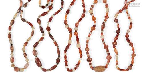 A group of five ancient and modern amber and glass bead necklaces, comprising round, biconical,