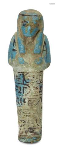 An Egyptian bright blue glazed composition shabti of typical form with black glazed details, holding