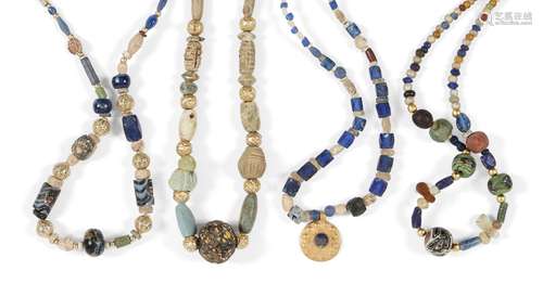 A group of four ancient and modern glass bead necklaces comprised of a necklace of faceted cobalt