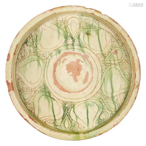 A large Byzantine scraffiato ware plate, 13th-14th century, with green glaze and incised decoration,