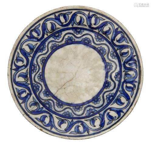 A Qajar pottery dish, Iran, 19th century, underglaze painted in cobalt and light blue, the centre