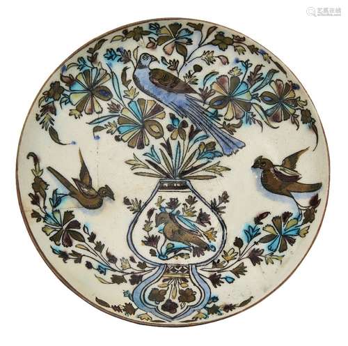 A Qajar dish with flowers and birds, Iran, 19th century, underglaze painted in cobalt, turquoise,