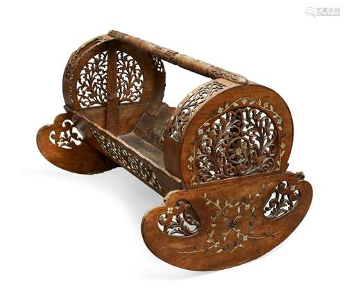 An Ottoman wooden cradle, Turkey, late 19th-early 20th century, with rounded openwork ends, inlaid