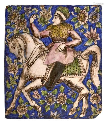 A Qajar moulded tile with woman on horseback, Isfahan, Iran, 19th century, underglaze painted in