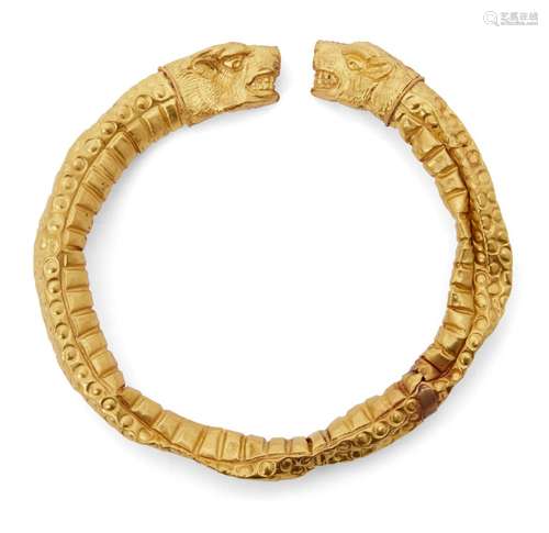 A reproduction Greek style gold bracelet, hollow with lion head terminals, with incised details