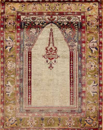 A Turkish silk prayer rug, 19th century, the ivory prayer arch with a hanging lantern and supporting