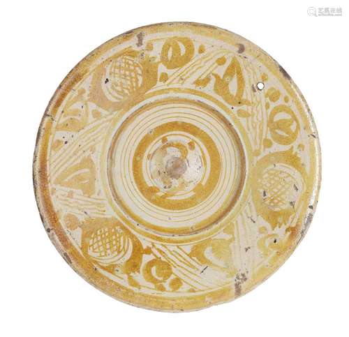 A Hispano-Moresque pottery dish, Spain, 17th century, the centre with raised well, the cavetto