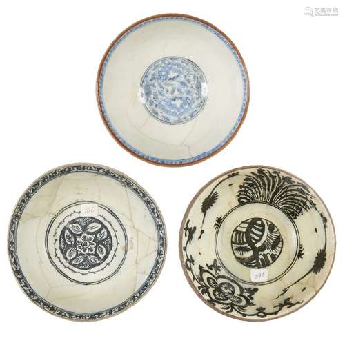 A group of three Safavid glazed pottery bowls, Iran, 17th century, each on straight foot with