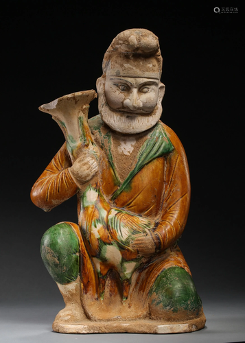 A TRI-COLORED PORCELAIN FIGURE