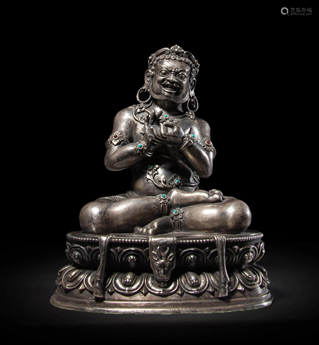 A TURQUOISE-INLAID SILVER SITTING TREASURE KING STATUE