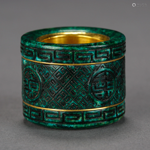 A CARVED GREEN QIU JIAO THUMB RING