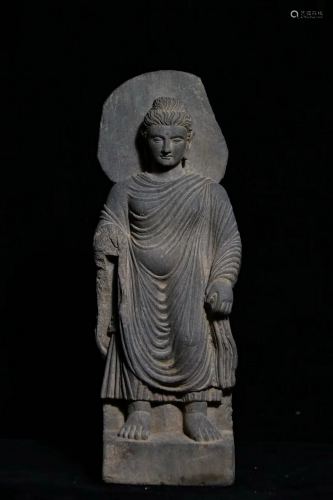 A STONE CARVED STANDING BUDDHA STATUE