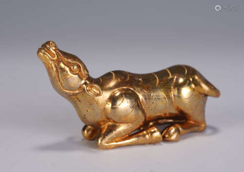 A CHINESE GILT BRONZE CATTLE SHAPED PAPERWEIGHT