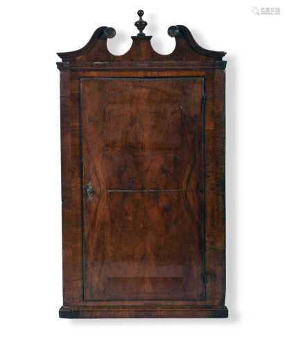 A George II walnut veneered hanging corner cupboard