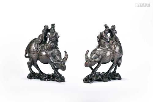 A pair of Chinese inlaid hardwood figure groups of boys on b...