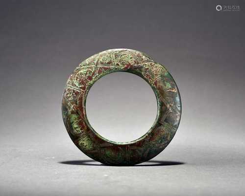 A Chinese silver-inlaid bronze harness ring, Zhou Dynasty/Wa...