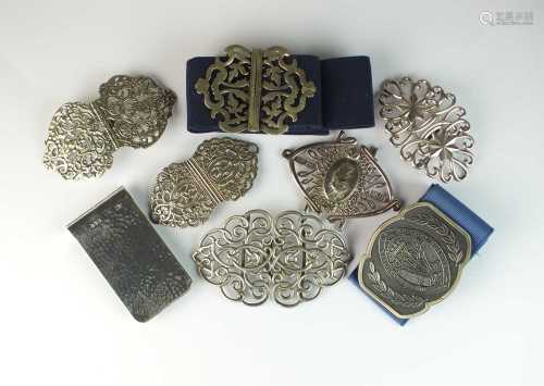 A collection of eleven nurses buckles