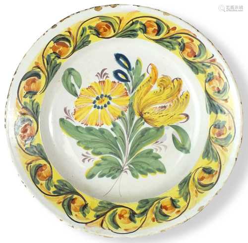 A polychrome Delft dish, 18th centurypainted in yellow, gree...