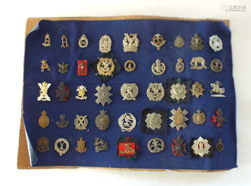 A collection of forty-five military cap badges
