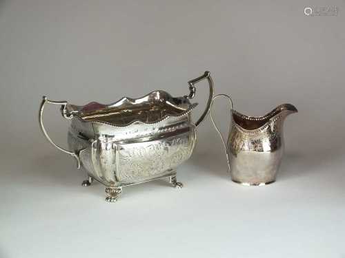 A silver sugar bowl and cream jug