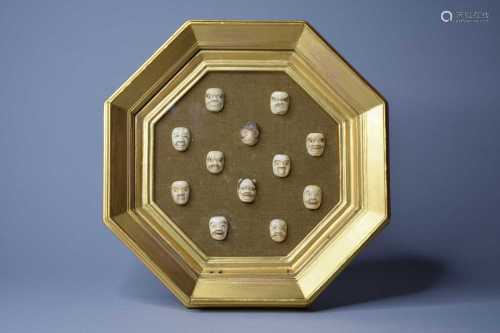 A framed set of Japanese miniature ivory masks of Oni
