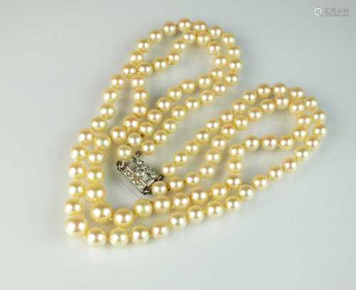 A two strand graduated cultured pearl necklace with diamond ...