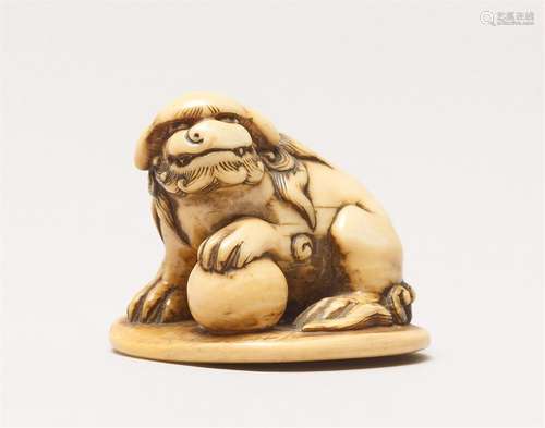 An ivory netsuke of a shishi with a ball. 19th century