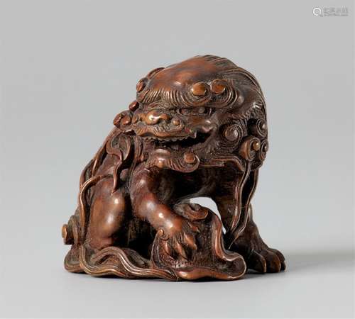 A boxwood netsuke of a shishi. 19th century