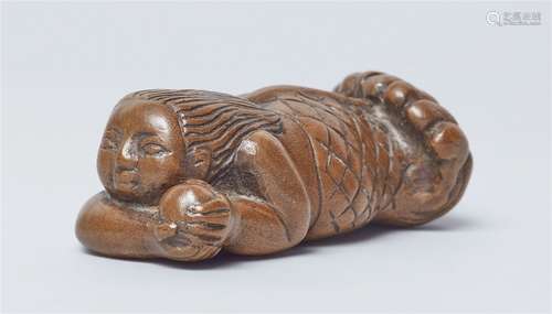 A large wood netsuke of a ningyo with a tama. Early 19th cen...