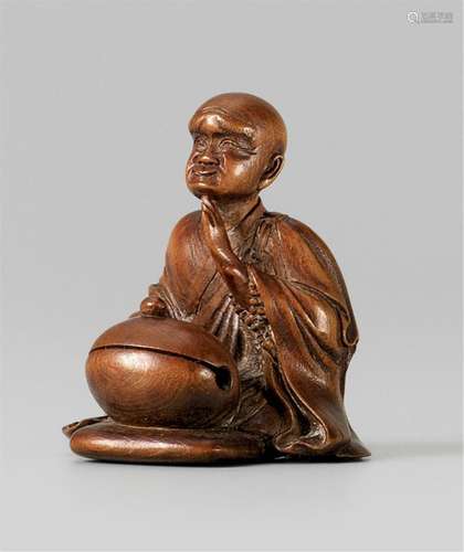 A Tokyo school wood netsuke of a seated monk. Around 1860-18...