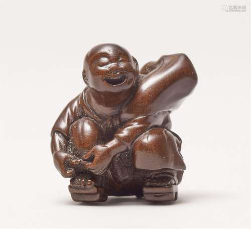 A fine wood netsuke of a biwa hoshi. Mid-19th century