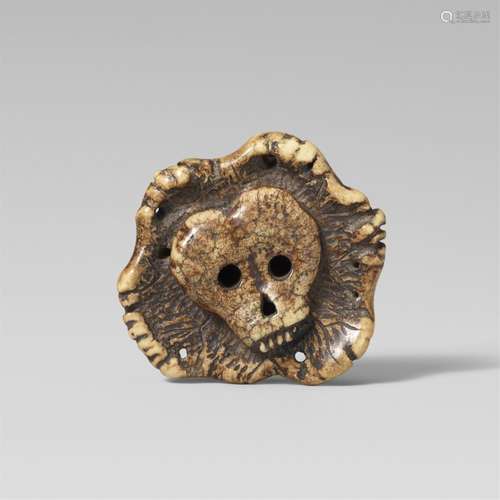 An unusual stag antler manju-type netsuke of a skull. Late 1...