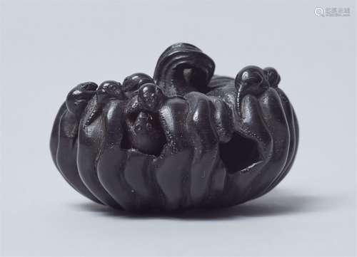 An ebony wood netsuke of rats in a pumpkin. 19th century