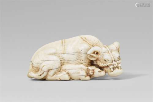 A large ivory netsuke of a recumbent ox and calf. Late 18th/...