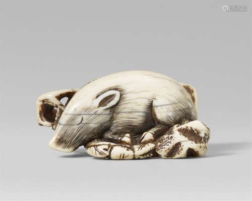 A good Kyoto school ivory netsuke of a recumbent boar on a b...