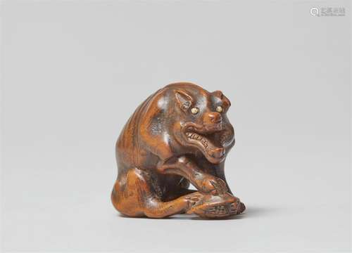 A large boxwood netsuke of a hungry wolf. Early 19th century