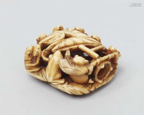 A walrus-tusk netsuke of a group of frogs. Late 19th century