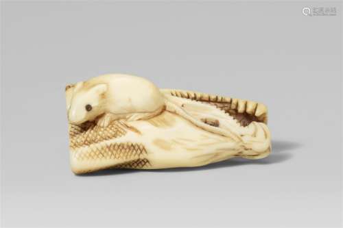 An ivory netsuke of a dried salmon head and a rat. First hal...