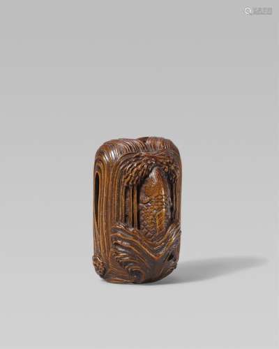 A large boxwood netsuke of a carp leaping up a waterfall. Ea...