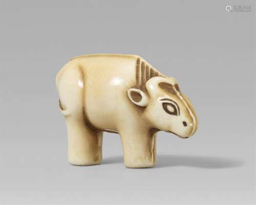 An Osaka school ivory netsuke of a toy figurine of an ox. Mi...