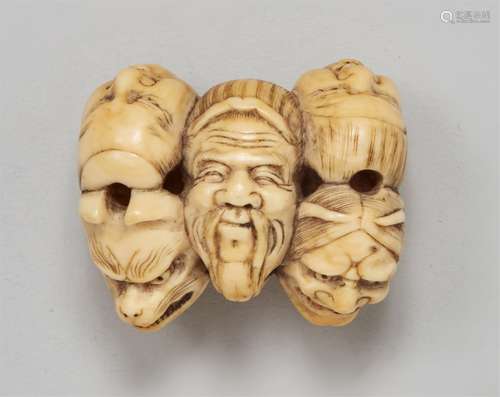 An ivory netsuke of a group of masks. Mid-19th century