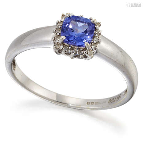 AN 18 CARAT WHITE GOLD TANZANITE AND DIAMOND CLUSTER RING