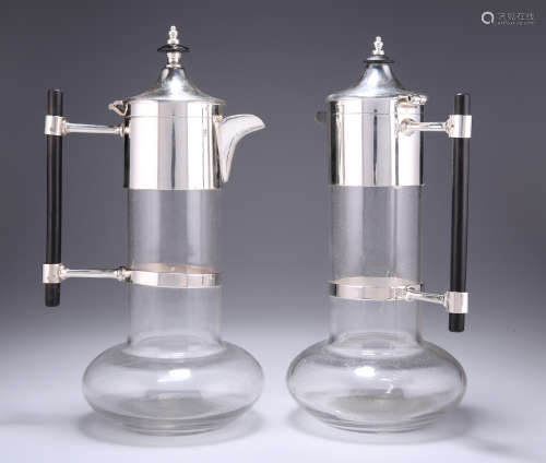 A NEAR PAIR OF SILVER-PLATE MOUNTED CLARET JUGS