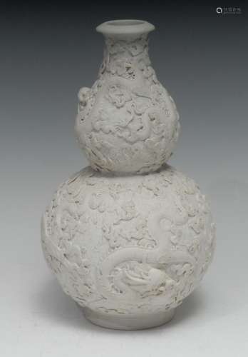 A Chinese biscuit porcelain double-gourd vase, in the white,...