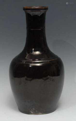A Chinese monochrome ovoid vase, glazed in tones of mottled ...