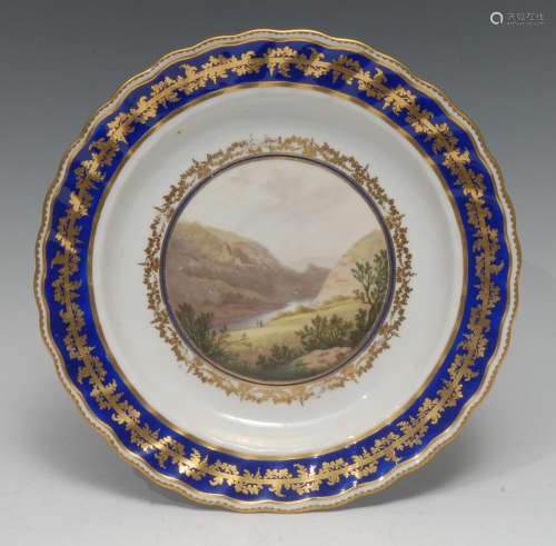 A Derby Named View shaped circular plate, painted by Zachari...